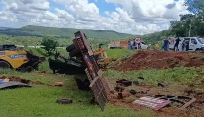 Caminhão carregando colheitadeira tomba às margens de rodovia