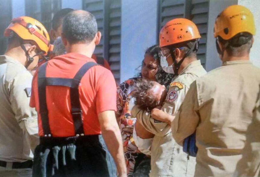 Bombeiros socorrem criança durante incêndio em apartamento de residencial no Bairro Lageado. (Foto: Marcos Maluf)