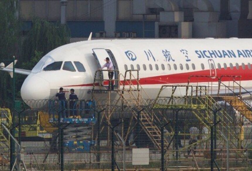 Funcionários inspeciam avião da Sichuan Airlines Foto: CHINA STRINGER NETWORK / REUTERS